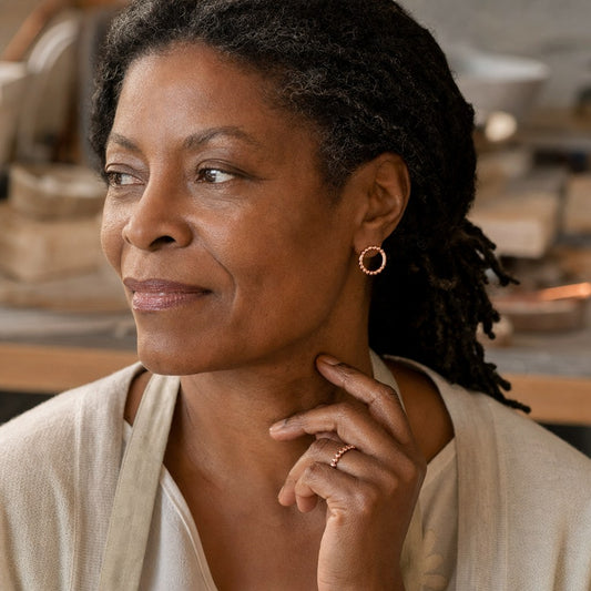 Smal Copper Earrings worn by a woman from our community