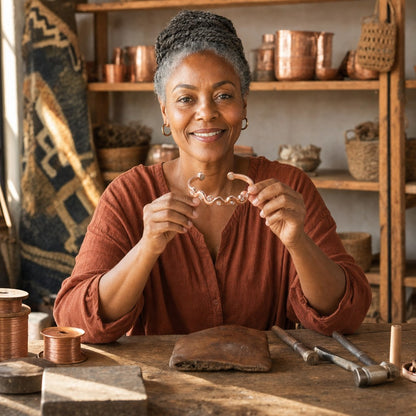 Our founder holding the Lark Copper Bracelet in her workshop